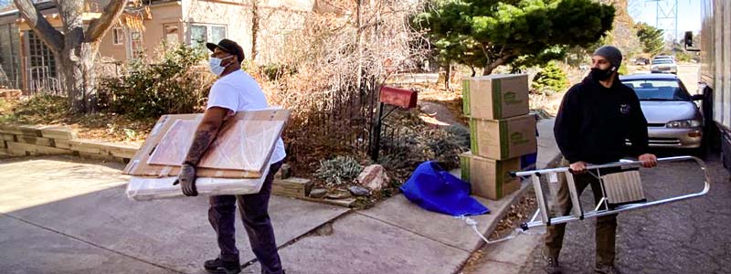 Professional movers covered with masks