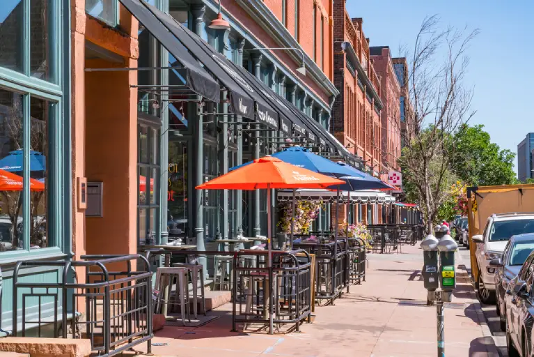 Outdoor dining and boutique shops along a lively street in Cherry Creek Denver.