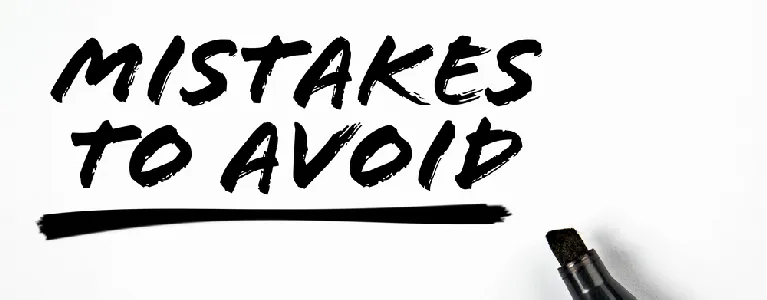 Close-up of a black marker writing “Mistakes to Avoid,” symbolizing common moving errors that increase costs in Denver relocations.