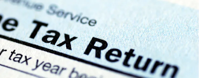 Close-up of a U.S. tax return form, highlighting potential moving-related tax deductions and employer assistance for Denver relocations.