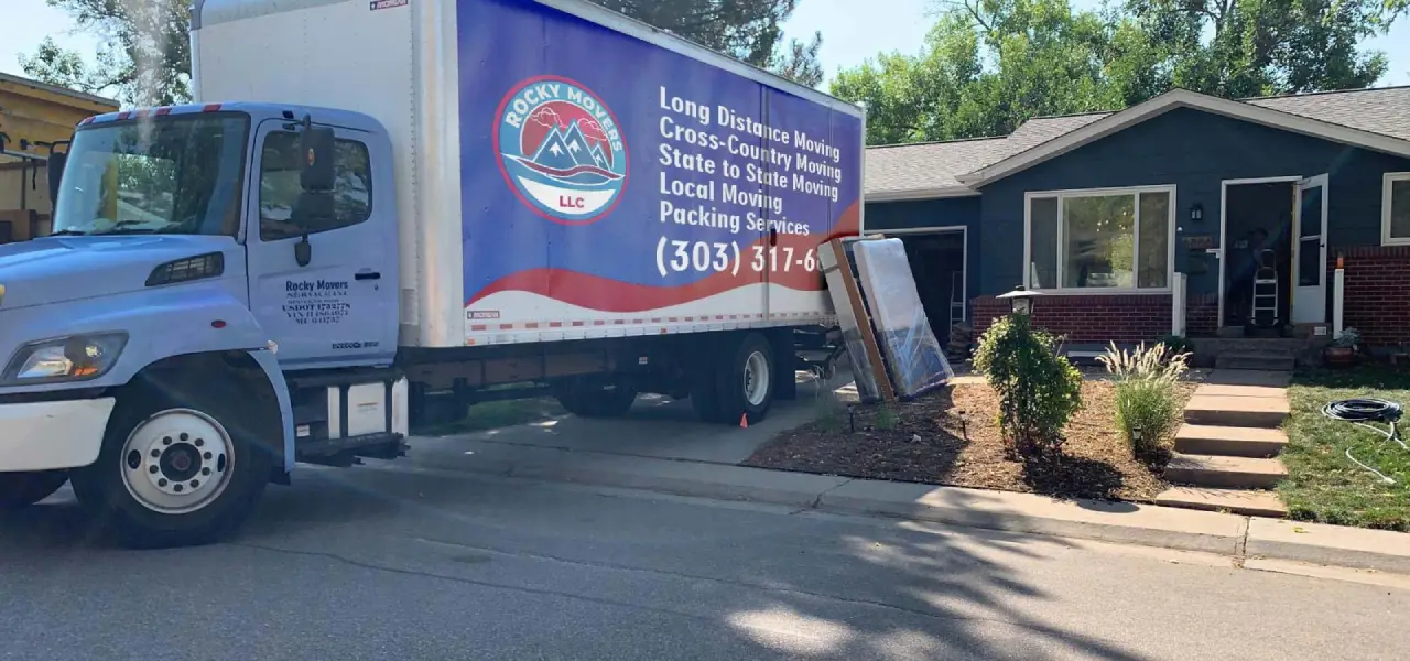 Rocky Movers' truck and crew at a home in Denver loading household goods for a relocation